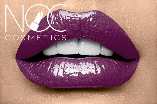 Close-up of lips wearing shiny deep purple Lipgloss - Purple Haze on smooth skin background.